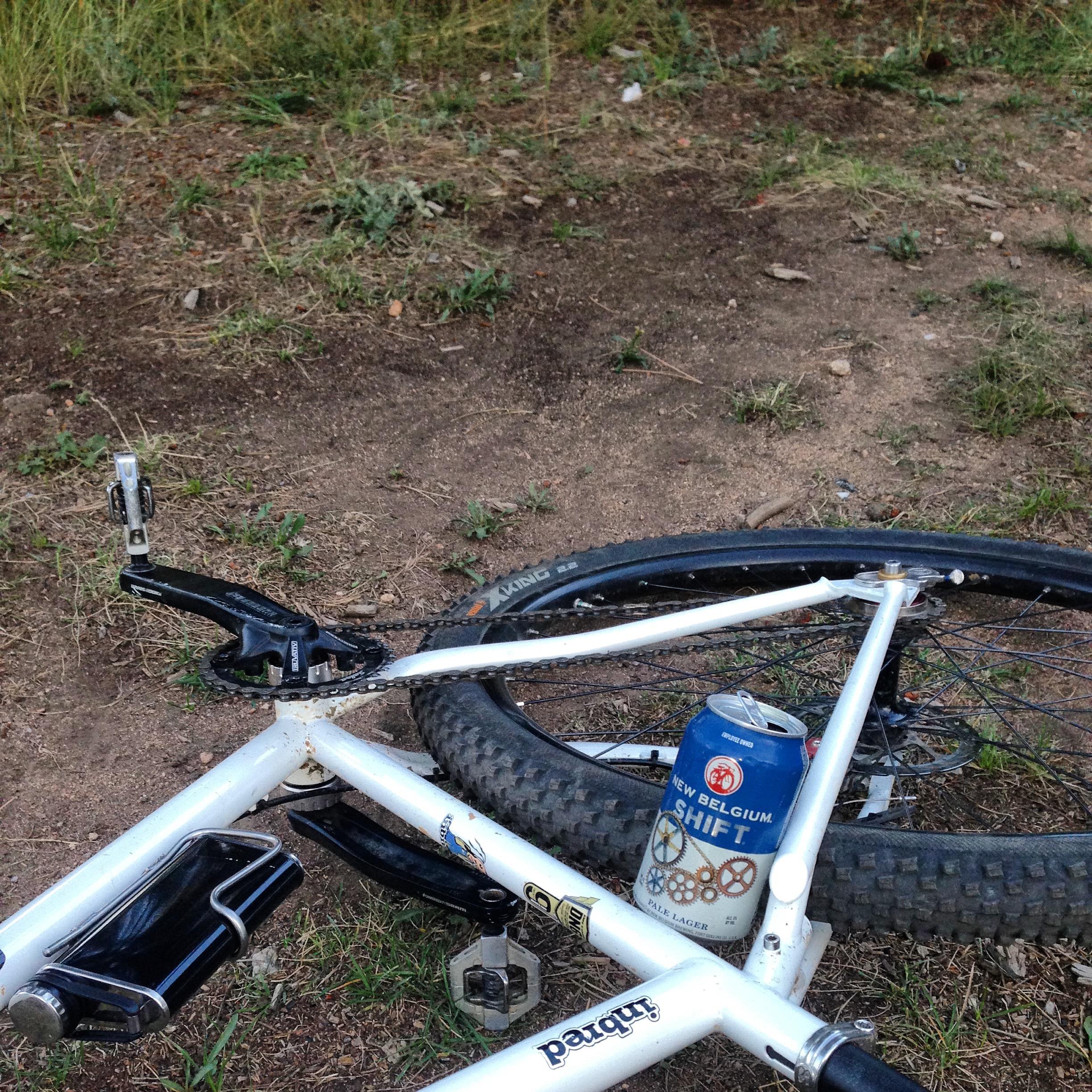 The Inbred leaning against a trail boundary sign at the edge of the woods