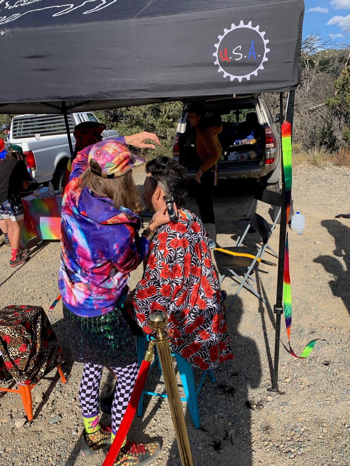 Riders in colorful costumes gathered at an aid station tent