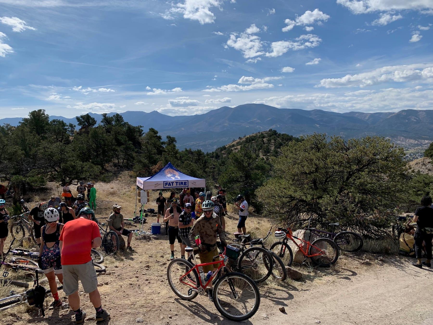 Aid station tent with mountains and blue sky in the background