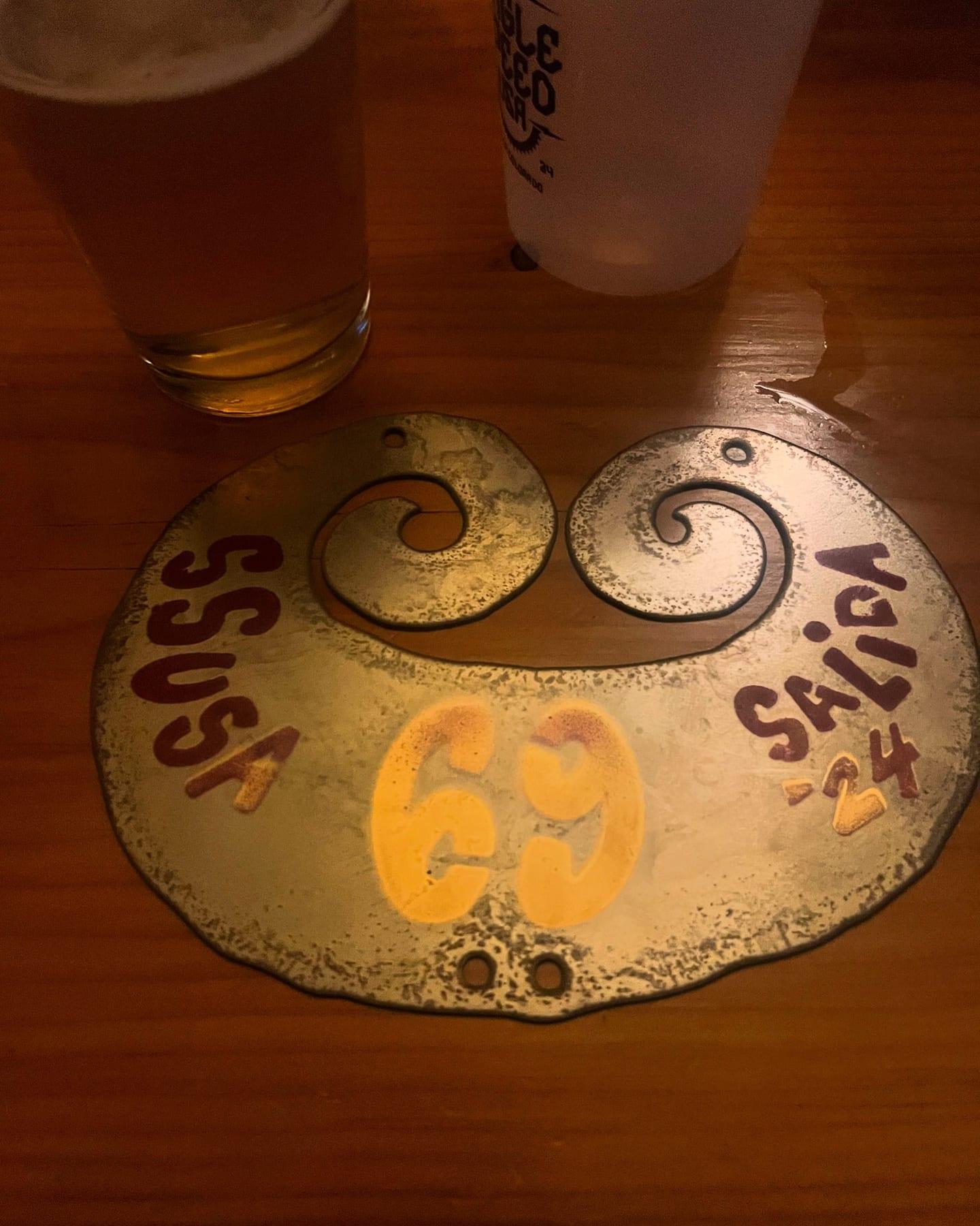 SSUSA Salida CO commemorative coaster on a bar table next to a beer
