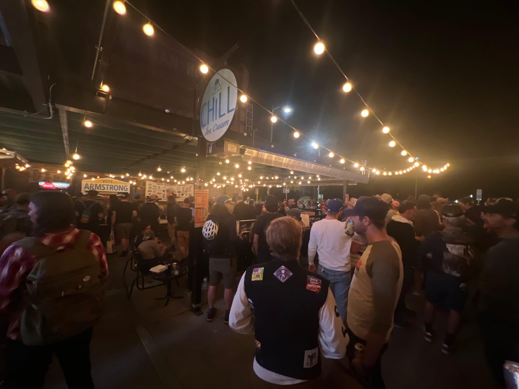 Crowd under string lights at the after-party