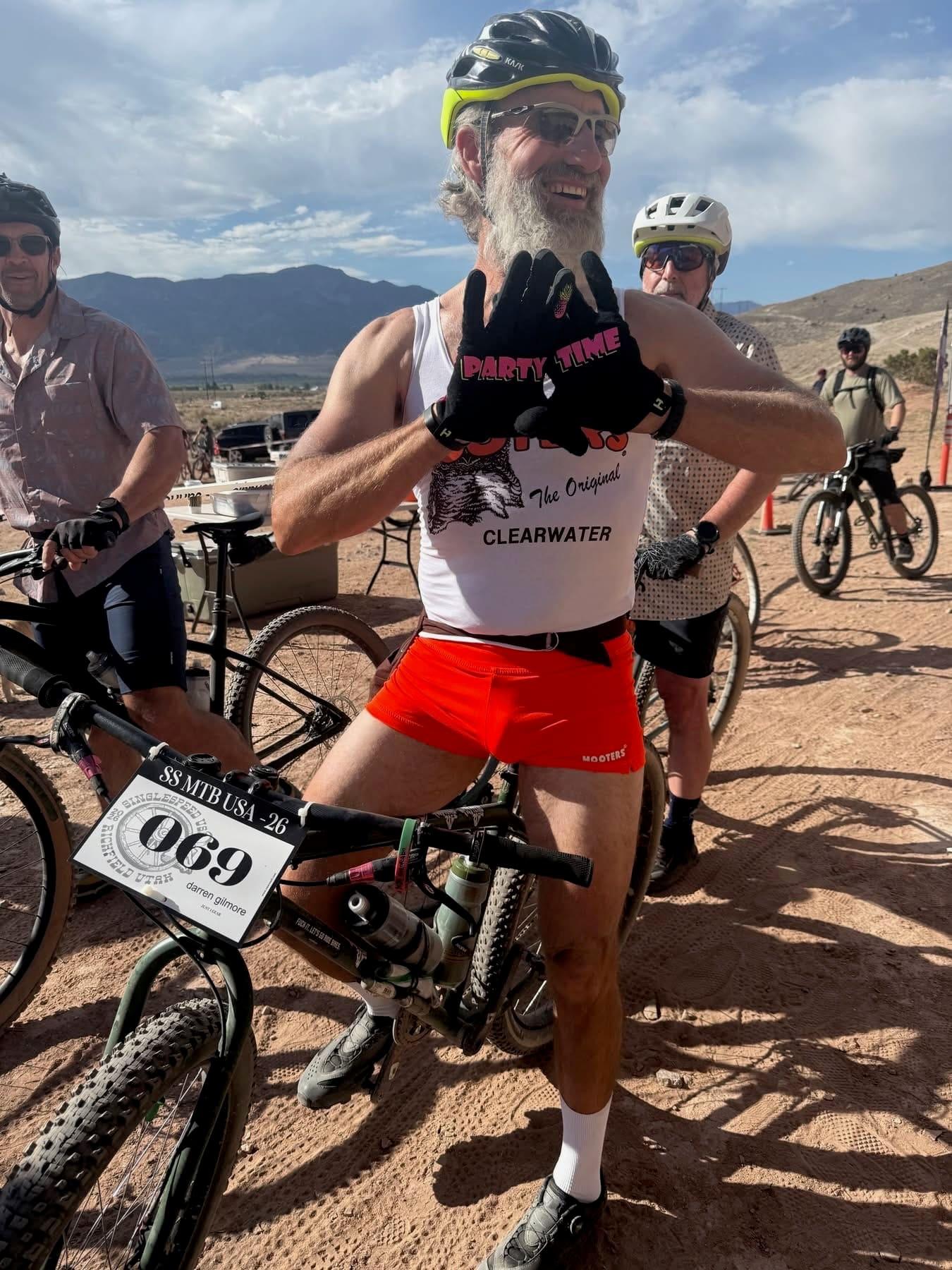 Group of costumed racers with bib numbers posing together at Single Speed USA