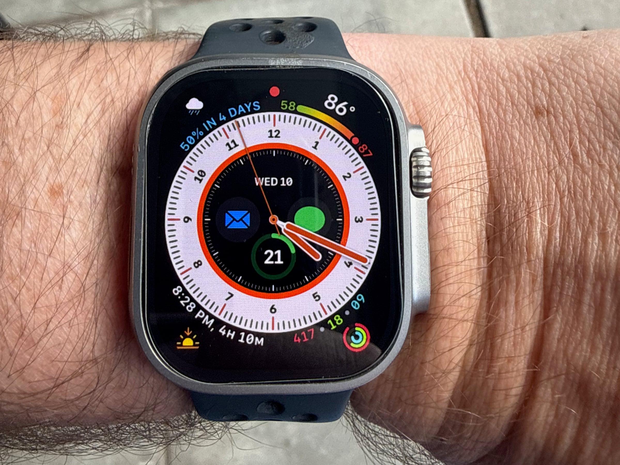 Apple Watch Ultra 2 on the wrist, showing a weather and activity watch face
