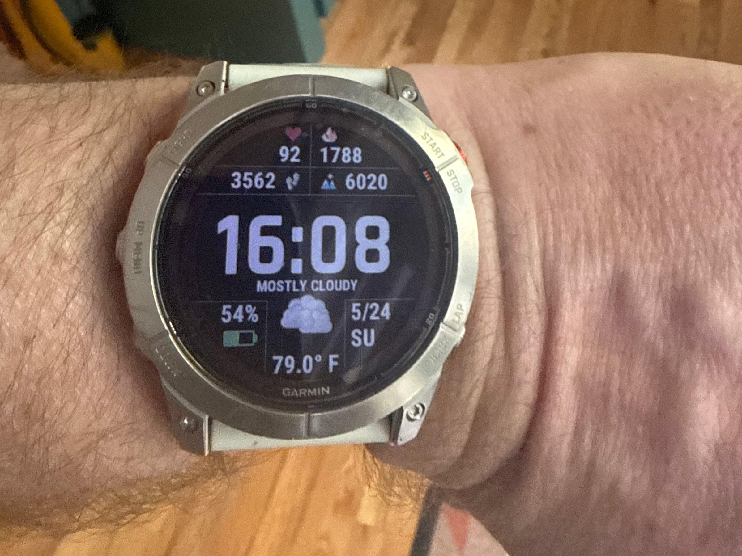Garmin Fenix 7X Pro Sapphire Solar on the wrist, showing a stats watch face