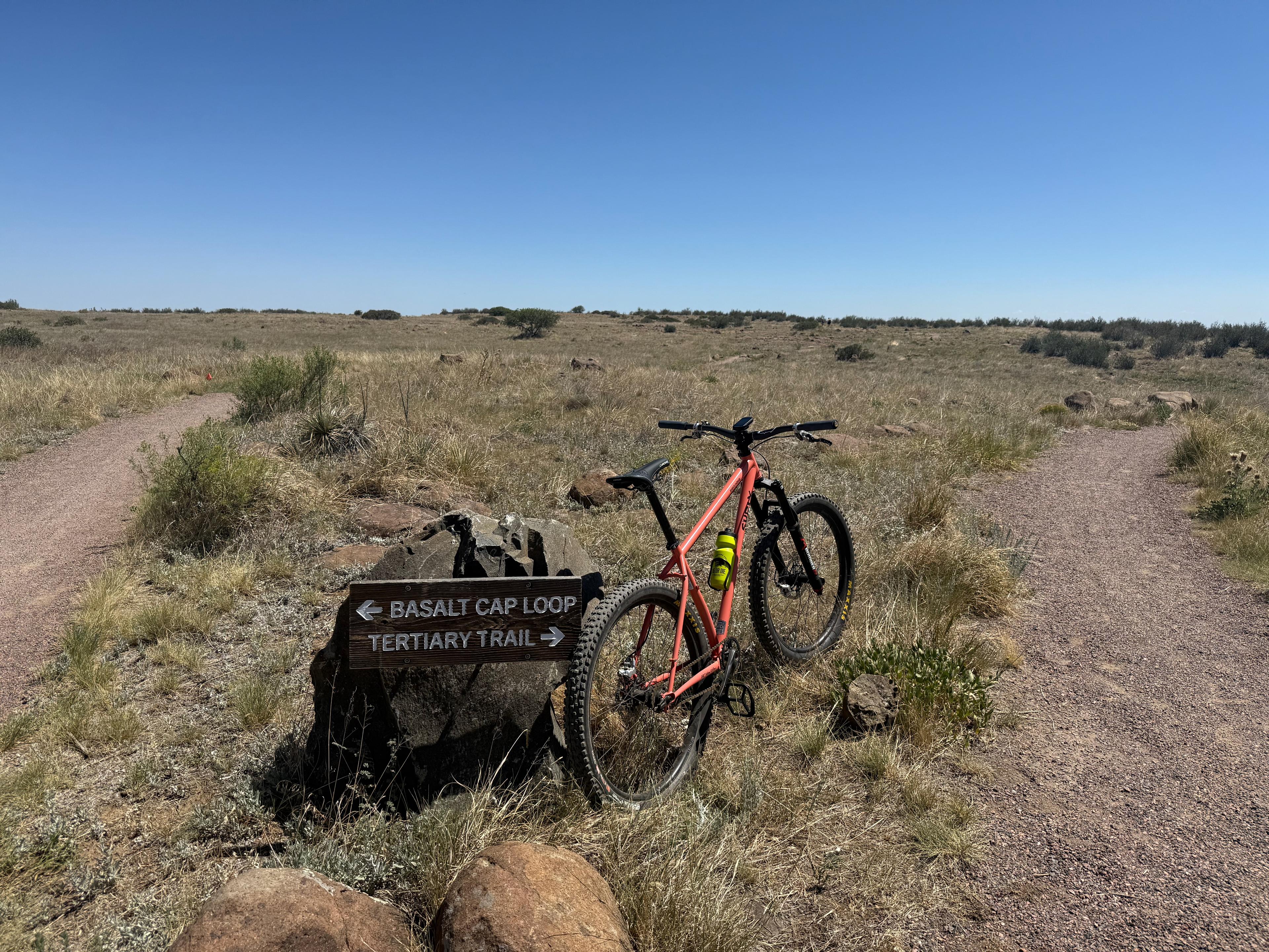 Close-up of a trail sign pointing left to Basalt Cap Loop and right to Tertiary Trail